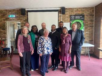 A group of people posing for a photo

AI-generated content may be incorrect.